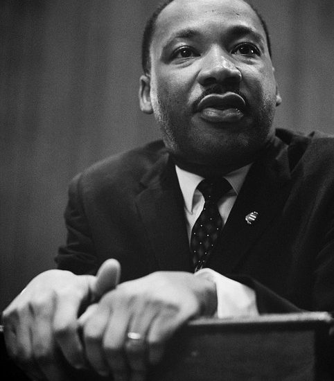 Image contains Dr. Martin Luther King Jr. at a podium.