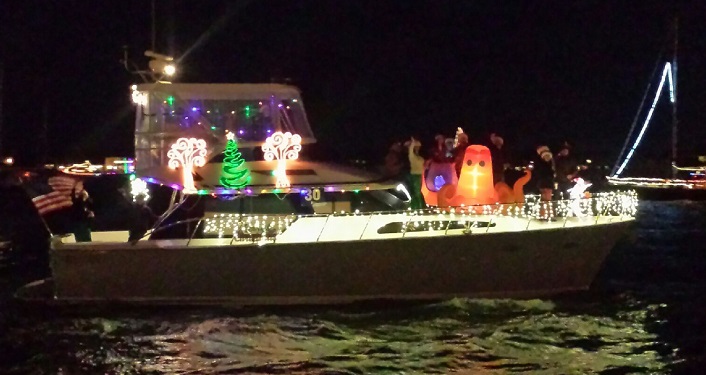 image of boat with Christmas decorations and lights participating in Holiday Regatta of Lights