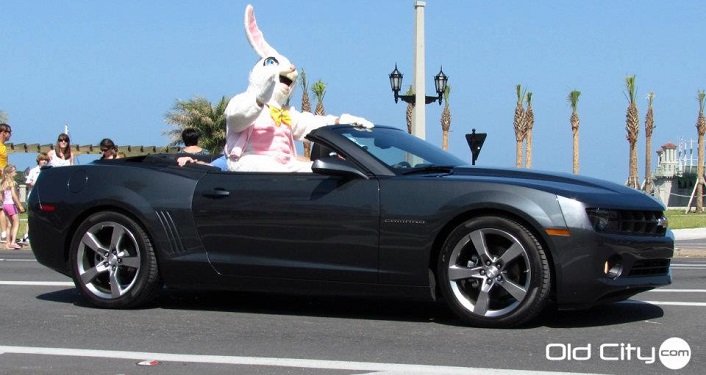 person dressed as Easter Bunny riding in convertible in the Easter Parade