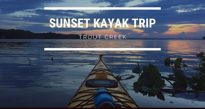 view of kayak looking towards sunset; text: Trout Creek Sunset Kayak Trip