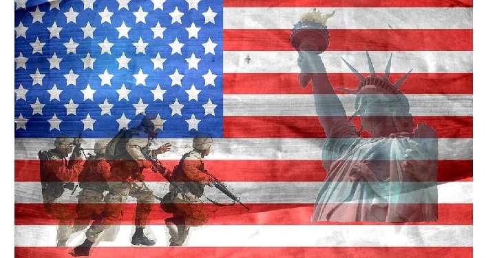 image of American Flag with Statue of Liberty shadowed in on right side; four soldiers dressed in combat gear, holding rifles on left side