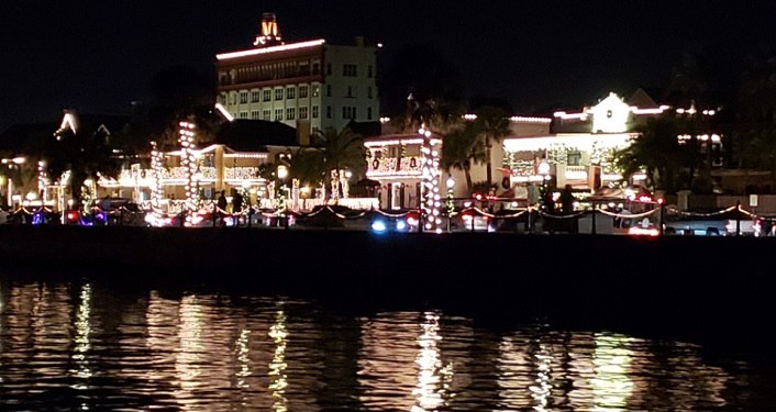 night time image of bayfront of St. Augustine seen from the water; building lit up with millions of tiny whtie lights for Nights of Lights