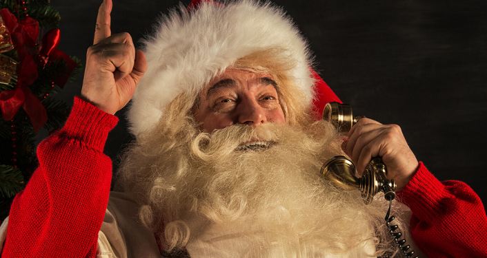 image of Santa Claus smiling, talking on the phone