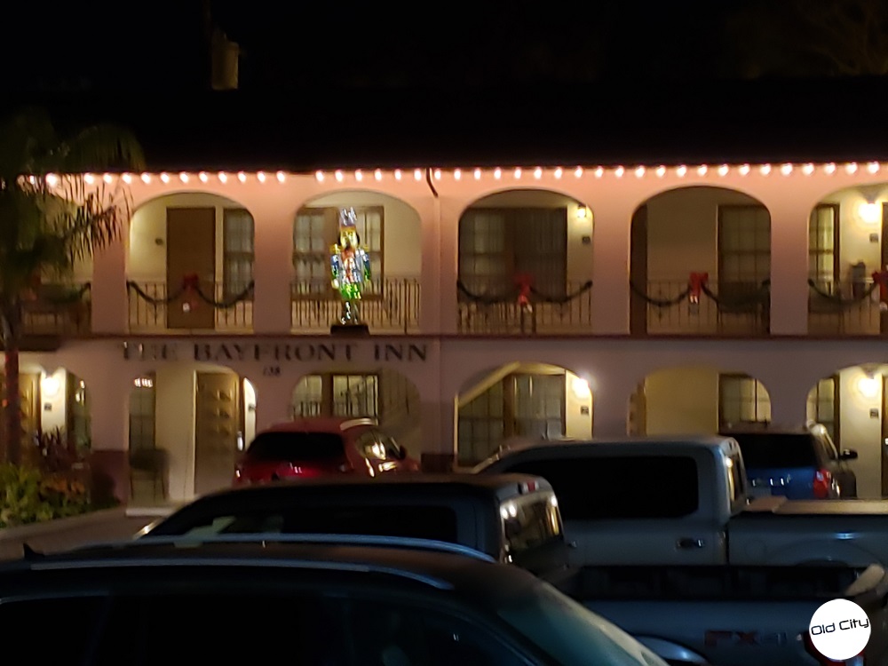 Image contains two floors of hotel rooms and holiday lights.