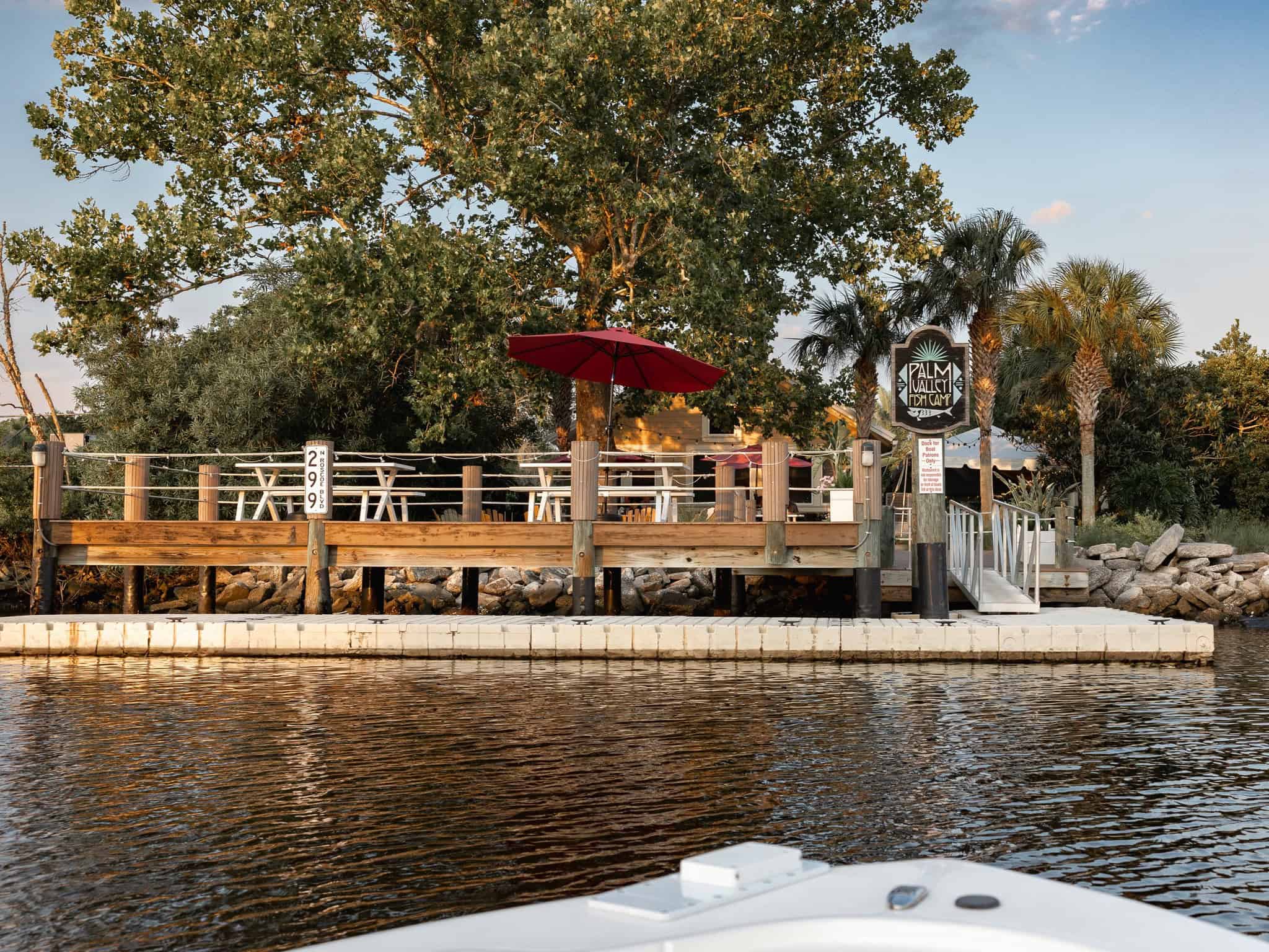 View from a boat of the patio seating area of Palm Valley Fish Camp in Ponte Vedra, FL.