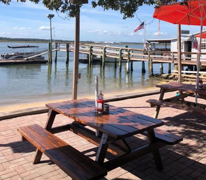 Patio table under a shady tree overlooking the pier from Aunt Kate's Restaurant in St. Augustine.