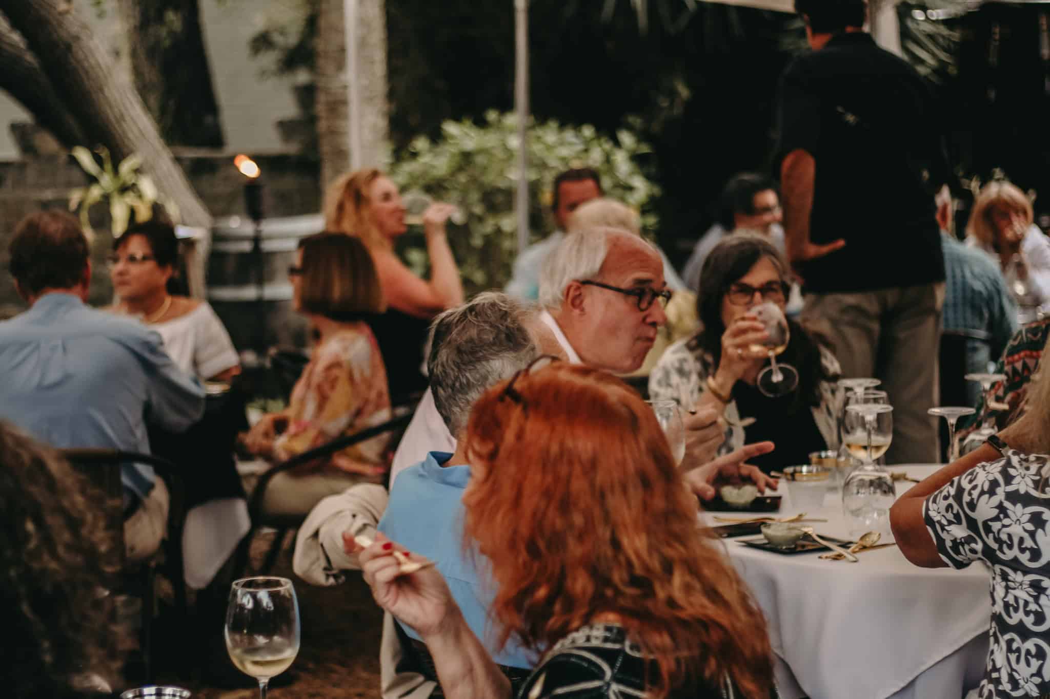 People dining and drinking wine outdoors at Casa de Vino in St. Augustine, FL.