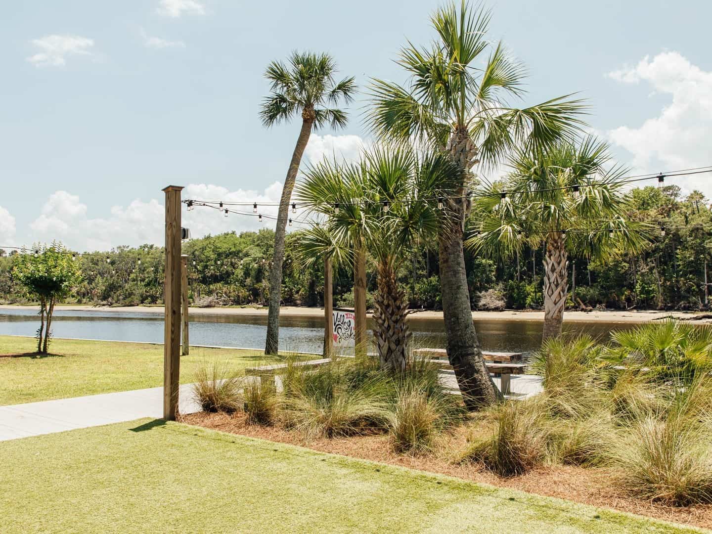 View of the Intercoastal Waterway and palm trees from the outdoor seating area at Valley Smoke Restaurant in Ponte Vedra, FL.