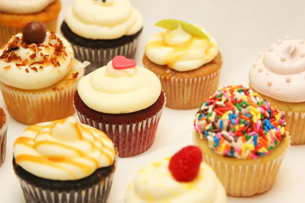 An assortment of cupcakes with colorful toppings.