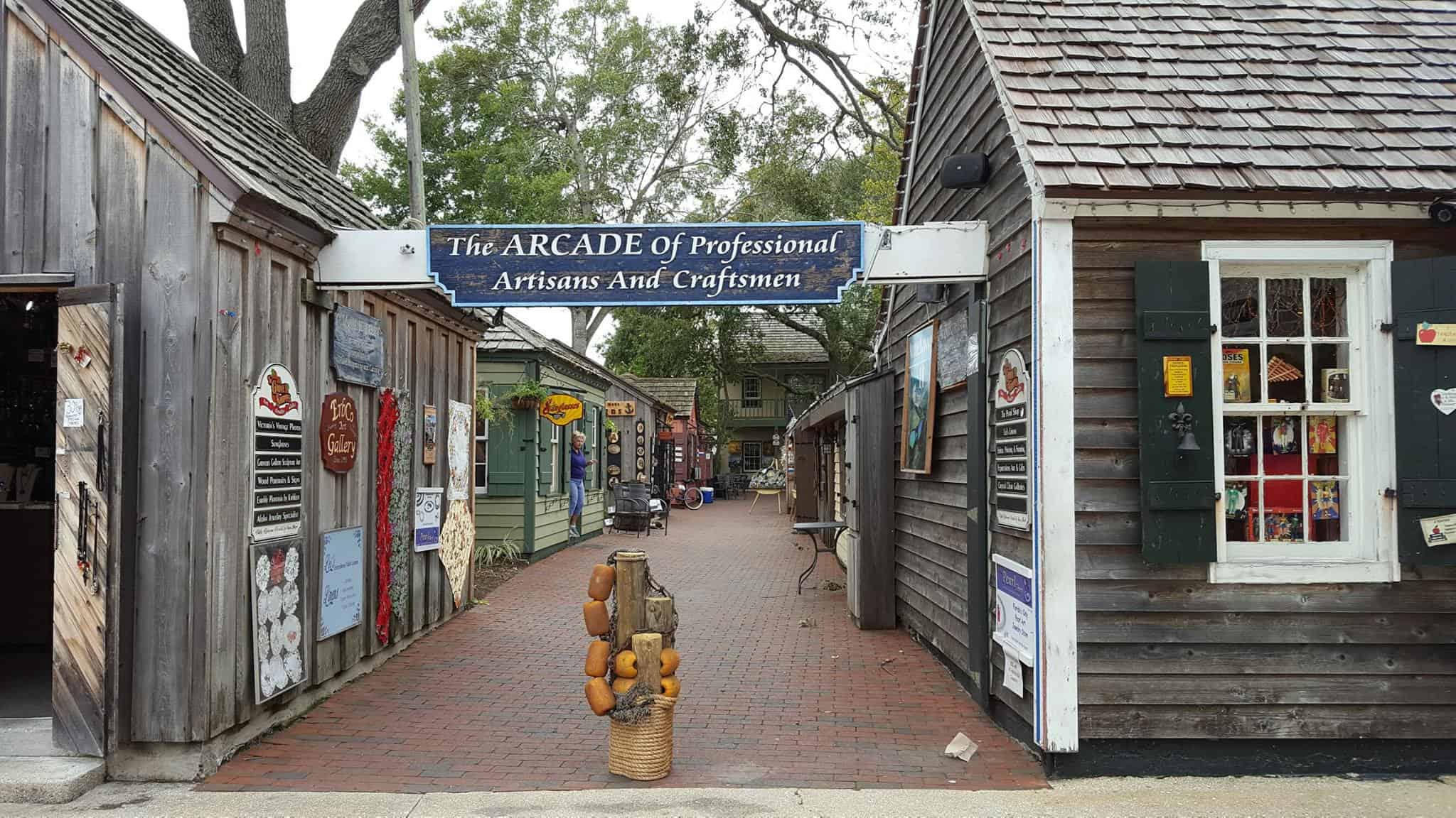 Small cobble-stone street lined with old timey wooden buildings