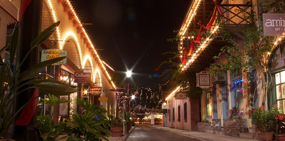 George St. at night. The building are decked out in festive decorations and white lights.