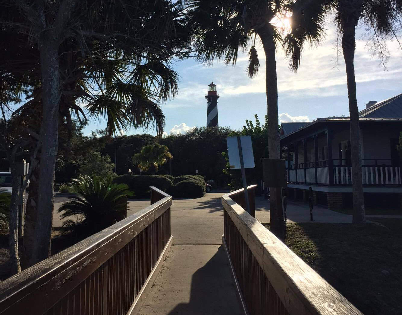 View of the St. Augustine Lighthouse & Maritime Museum from a wooden nature walkway.