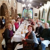 Image of a large group of people sitting at a long table. 
